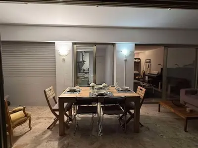 a dining room table and chairs in a room at 13 Rue Edith Cavell in Cannes