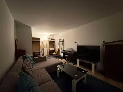 a living room with a couch and a piano at 13 Rue Edith Cavell in Cannes