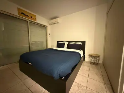 a bedroom with a large bed in a room at 13 Rue Edith Cavell in Cannes