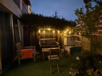 a patio with chairs and a table and lights at 13 Rue Edith Cavell in Cannes