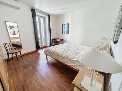 a bedroom with a bed and a table with a lamp at Luxury 1 bedroom Quai St Pierre 2 mins from the Palais & Croisette 269 in Cannes