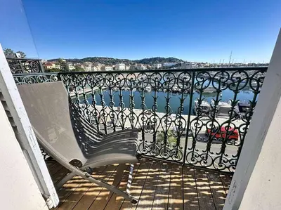 a bench on a balcony with a view of the water at Luxury 1 bedroom Quai St Pierre 2 mins from the Palais & Croisette 269 in Cannes
