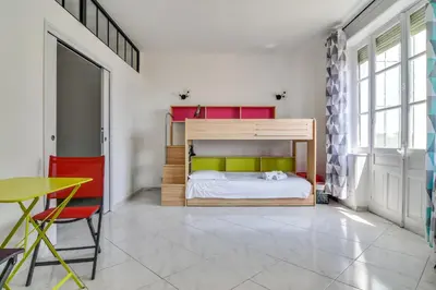 a bedroom with a bunk bed and a table at IMMOGROOM - Sea View - Balcony - 5 min from the beach - AC - Wifi in Cannes
