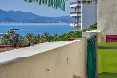 a retaining wall with a view of the ocean at IMMOGROOM - Sea View - Balcony - 5 min from the beach - AC - Wifi in Cannes