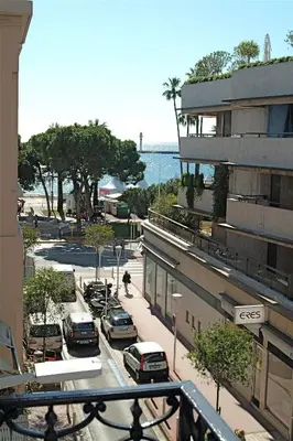 a street with cars parked in a parking lot next to a building at Golden Triangle 2Br/2Ba in Cannes