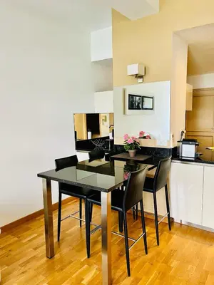 a black dining room table with black chairs in a kitchen at Golden Triangle 2Br/2Ba in Cannes