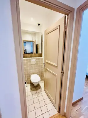 a bathroom with a toilet and a door at Golden Triangle 2Br/2Ba in Cannes