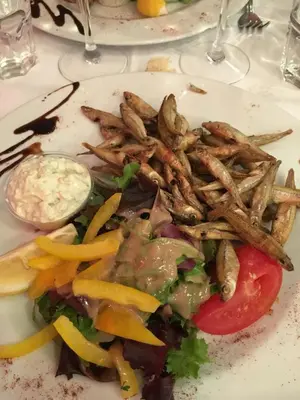 a plate of food with french fries and a salad at Golden Triangle 2Br/2Ba in Cannes