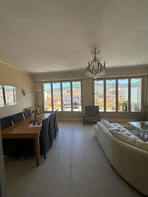 a living room with a chandelier and a table and chairs at Cannes Satellite in Cannes