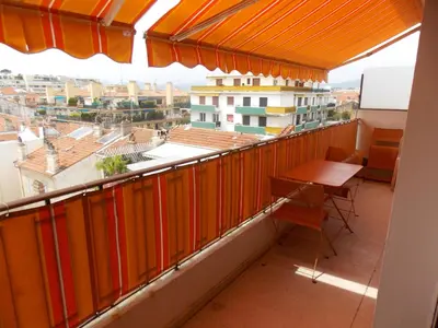 a balcony with a table and a view of a city at Cannes Satellite in Cannes