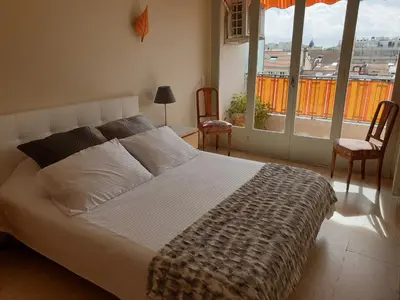 a bedroom with a bed and two chairs and a window at Cannes Satellite in Cannes