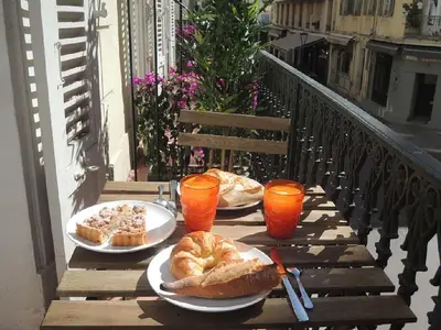 a table with three plates of food on a balcony at Luxury Family 2BR - Prime Location, Walk to Beach & Shopping, Sunny Balcony - By Totolulu Cannes Hoche in Cannes