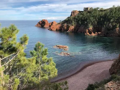 a view of a beach with trees and the ocean at Luxury Family 2BR - Prime Location, Walk to Beach & Shopping, Sunny Balcony - By Totolulu Cannes Hoche in Cannes