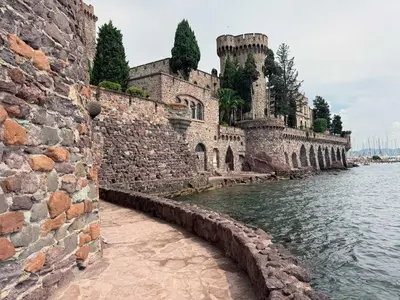 a stone wall next to a body of water at Luxury Family 2BR - Prime Location, Walk to Beach & Shopping, Sunny Balcony - By Totolulu Cannes Hoche in Cannes