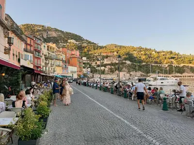 a group of people walking down a street at Luxury Family 2BR - Prime Location, Walk to Beach & Shopping, Sunny Balcony - By Totolulu Cannes Hoche in Cannes