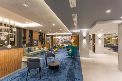 a lobby of a hotel with chairs and tables at Nemea Appart Hotel Cannes Palais in Cannes