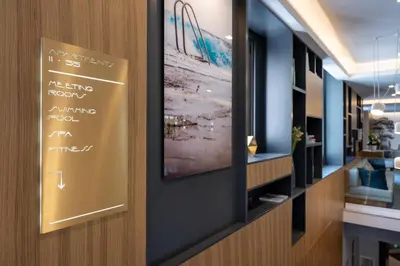 a sign on the wall of a hotel room with writing on it at Nemea Appart Hotel Cannes Palais in Cannes