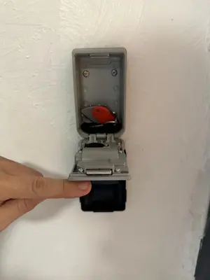 a hand pointing at a light in a wall at Safari apartment in heart of Cannes and beaches in Cannes