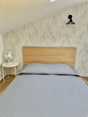 a bedroom with a bed with a wooden head board at Safari apartment in heart of Cannes and beaches in Cannes