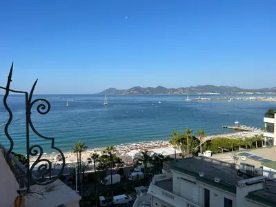 a view of the beach and ocean from a building at Croisette Palais Miramar - sea view in Cannes