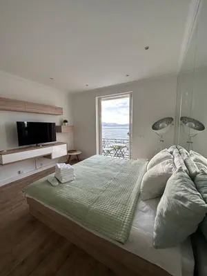 a bedroom with a large bed with a large window at Croisette Palais Miramar - sea view in Cannes