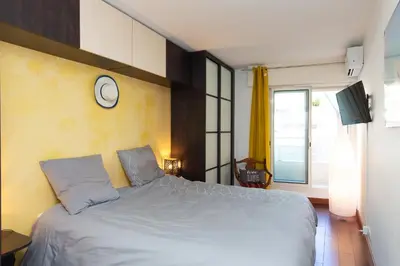 a bedroom with a bed with a clock on the wall at Villa AD’ALTA in Cannes