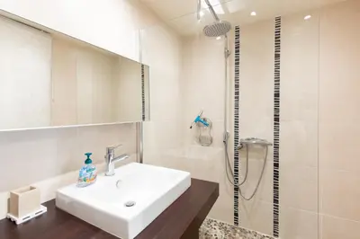 a white bathroom with a sink and a shower at Villa AD’ALTA in Cannes