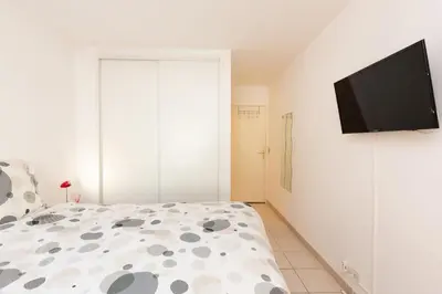 a bedroom with a bed and a flat screen tv at Villa AD’ALTA in Cannes