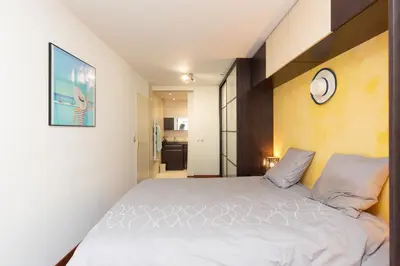 a bedroom with a bed and a clock on the wall at Villa AD’ALTA in Cannes