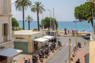 a group of motorcycles parked on a street near the ocean at Croisette View Lux Flat Cannes in Cannes