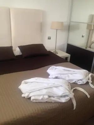 a bedroom with a bed with white sheets on it at Croisette View Lux Flat Cannes in Cannes