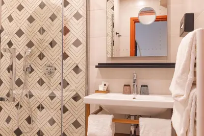 a bathroom with two sinks and a green ceiling at Hotel Verlaine in Cannes