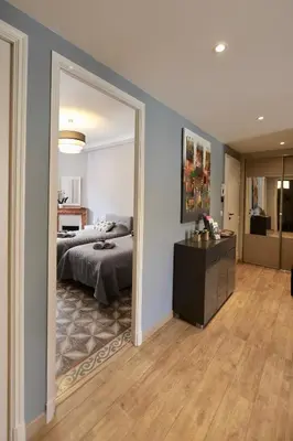 a bedroom with a bed and a large mirror at 70m2 Apartment - La Roseraie in Cannes