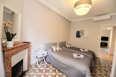 a bedroom with a bed and a fireplace at 70m2 Apartment - La Roseraie in Cannes