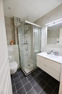 a bathroom with a shower and a sink and a toilet at 70m2 Apartment - La Roseraie in Cannes