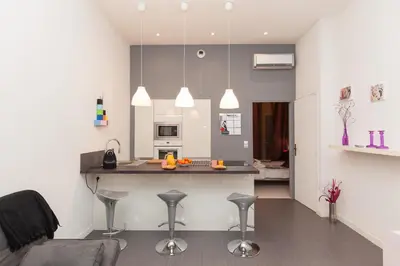 a kitchen with a island in the middle of a room at Marylin 2 pièces 3 étoiles, plein coeur de Cannes, 5mn Palais et plages in Cannes