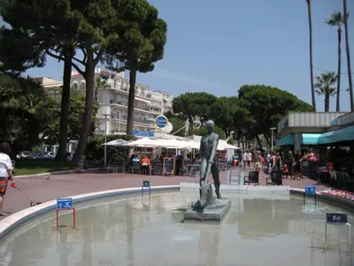 a statue sitting in a fountain in a city at Marylin 2 pièces 3 étoiles, plein coeur de Cannes, 5mn Palais et plages in Cannes