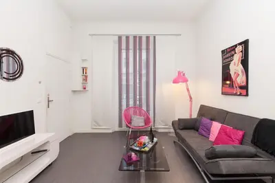 a living room with a couch and a television at Marylin 2 pièces 3 étoiles, plein coeur de Cannes, 5mn Palais et plages in Cannes