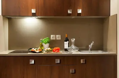 a kitchen counter with a sink and some vegetables on it at Nehô Suites Cannes Croisette in Cannes
