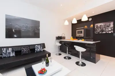 a living room with a bar and a kitchen at New York 2 pièces 3 étoiles calme plein centre de cannes, 5mn des plages et Palais in Cannes