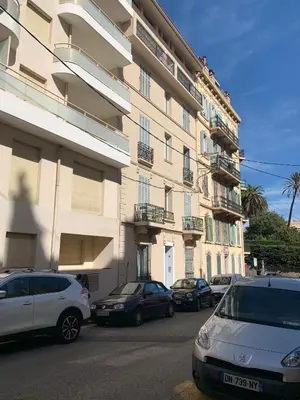 a group of cars parked in front of a building at Nature 2 pièces 3 étoiles calme plein centre cannes 5 mn des plages et Palais in Cannes