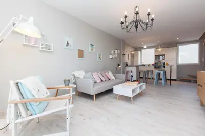 a living room with a couch and a table at Cocooning 3 pièces duplex 3 étoiles calme centre ville à 5mn plages et Palais in Cannes