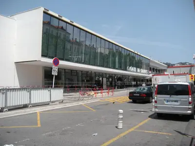 a van parked in a parking lot in front of a building at Cocooning 3 pièces duplex 3 étoiles calme centre ville à 5mn plages et Palais in Cannes