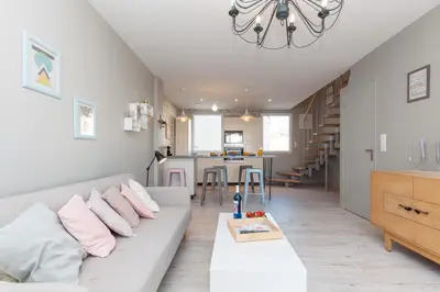 a living room with a couch and a table at Cocooning 3 pièces duplex 3 étoiles calme centre ville à 5mn plages et Palais in Cannes