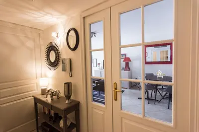 a door leading to a dining room with a table at Le Parc Pointe Croisette in Cannes