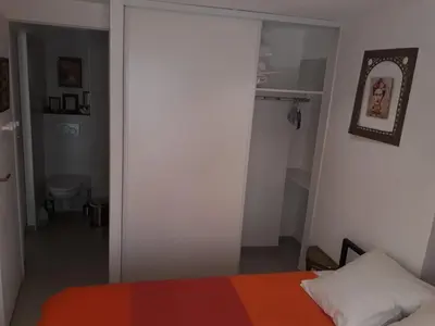 a bedroom with a bed and an open door at Le Tivoli in Cannes