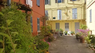 an alley in an old town with flowers at Le Tivoli in Cannes