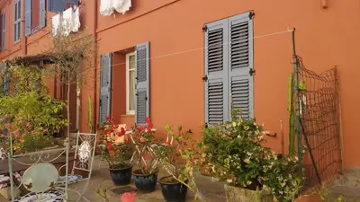 an orange building with plants in front of it at Le Tivoli in Cannes