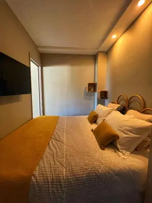a bedroom with a large white bed with yellow pillows at Les Roses by Welcome to Cannes in Cannes