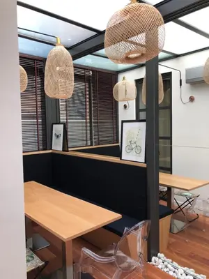 a dining room with two tables and two windows at Appartements Urban et Pure in Cannes